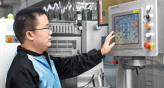 a worker is manipulating the machine