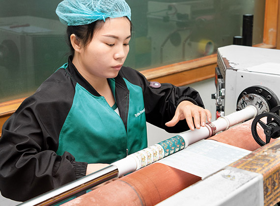 a worker is using the rewinding machine